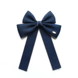Navy blue ribbon bow hair clip, elegant uniform hair accessory with metallic accent for professional use.