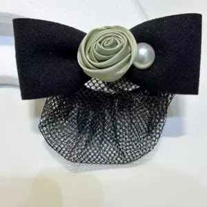 Detailed view of black fabric bow hair clip with green satin rose, pearl and mesh net.