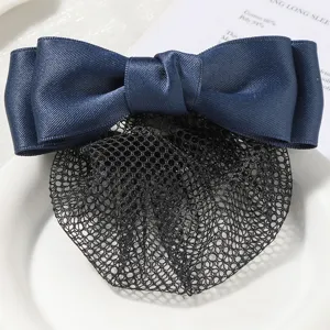 Detailed close-up view of dark blue satin bow and black hair net, professional bun cover.