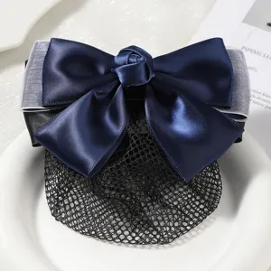 Detailed close-up of a sweet dark blue satin bow hair net with a delicate rose knot design.