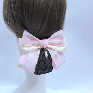Close-up detail of the elegant pink floral hair net bow with pearl pendant for professional buns.
