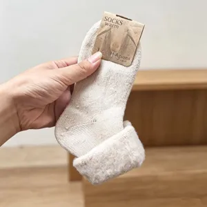 Detailed view of thick beige fleece socks with paper tag, warm winter cozy women socks