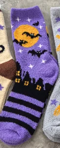 Halloween plush fuzzy sleep socks featuring cute bat and moon patterns, soft cozy warm home socks detail.