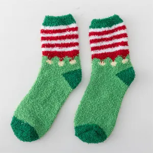 Detail view of fluffy Christmas microfiber socks in green and red with cozy texture.