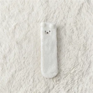 White fuzzy coral fleece socks with cute 3D bear ears and sweet embroidered face detail.