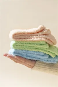 Soft coral fleece fuzzy socks detail closeup, cozy plush texture in pastel candy colors.