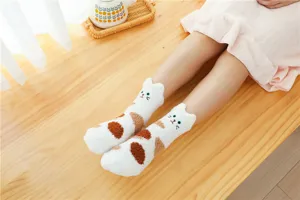 Cozy fuzzy coral fleece cat socks detail, soft warm winter sleep floor socks texture.