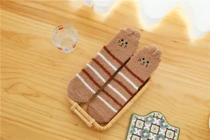 Cozy brown coral fleece fuzzy socks detail showing soft striped texture and cute embroidery.
