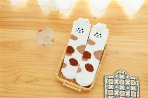 Close-up detail of fluffy coral fleece cat slipper socks, soft plush warm winter sleep socks.