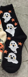 Halloween fuzzy sleep socks with cute ghost and pumpkin patterns for cozy home wear.