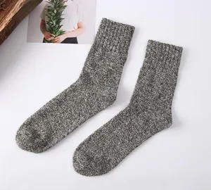 Close up view of cozy mens winter thick knit marl wool crew socks detail display.