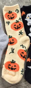 Halloween fuzzy sleep socks with cute pumpkin and ghost patterns, soft plush home wear detail.