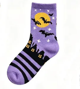 Halloween purple fuzzy sleep sock detail, soft plush fabric with bat and castle pattern.