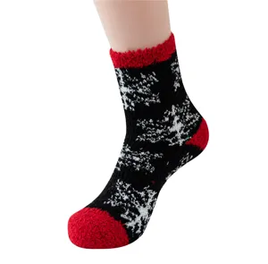 Detailed view of black and red fuzzy Christmas snowflake thermal sleep socks for cozy indoor wear.