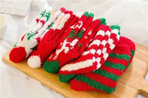 Detailed close-up of cozy Christmas fuzzy socks with red and white stripes for winter warmth.
