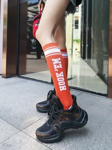Orange knee high socks with white stripes and letter print, trendy Japanese style cotton hosiery.