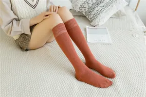 Cozy winter thick long socks for women, warm cotton tube stockings in vibrant orange color.