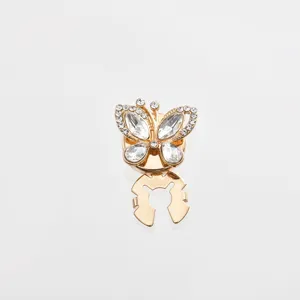 Detail shot of a sparkling rhinestone butterfly scarf buckle and chic clothing accessory.