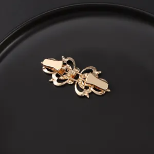 Gold vintage collar clip detail view, elegant metal shawl fastener and dress accessory.