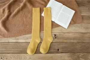 Comfortable winter yellow calf socks detail, warm cotton knit long stockings for cozy daily wear.