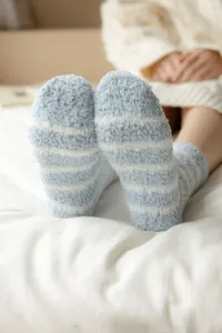 Cozy blue and white striped fuzzy sleep socks for women, thick coral fleece winter home socks.