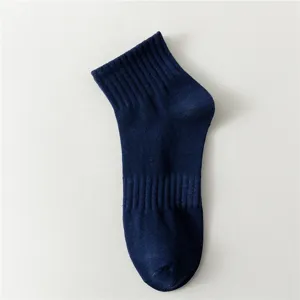 Detailed close-up view of dark blue men's mid-tube cotton sports sock fabric texture.