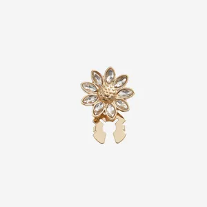 Close-up of elegant gold-plated crystal sunflower rhinestone shirt button cufflink detail.