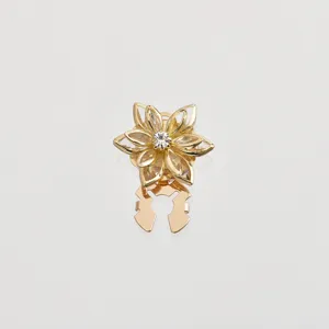 Gold lotus flower detail shot, vintage crystal brooch shirt collar pin and scarf buckle accessory.