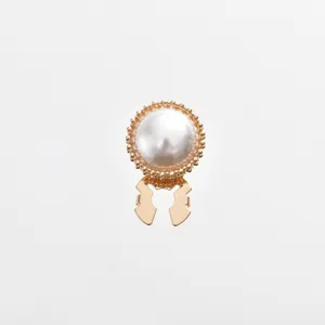 Pearl cufflink detail shot showing gold beaded border and round white pearl button craftsmanship.