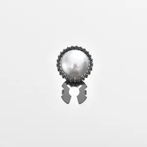 Detailed close-up of an elegant pearl rhinestone cufflink with secure backing for women shirts.