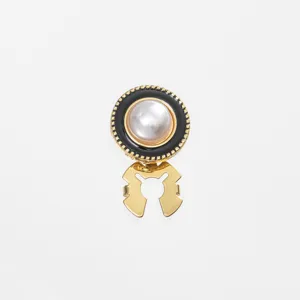 Detailed view of a chic pearl and black enamel brooch button, perfect for collar or scarf.