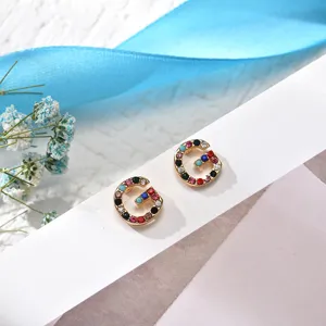 Detail view of the elegant letter G rhinestone earrings, featuring colorful sparkling crystal stones.