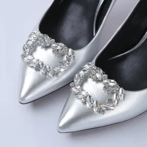 Silver pointed high heels detail shot showcasing exquisite sparkling rhinestone crystal buckle.