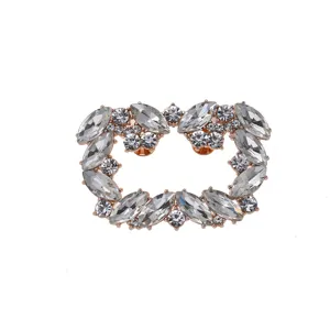Exquisite close-up detail of sparkling rhinestone shoe buckle with rose gold metal base.