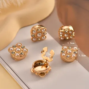 Detail view of elegant gold pearl decorative buttons, perfect for shirts and cardigans.
