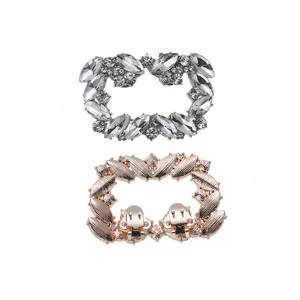 Detailed view of sparkling rhinestone and rose gold metal shoe clips, exquisite accessories.