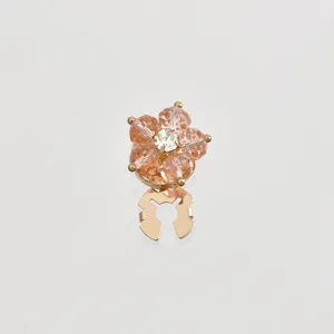 Detailed view of the sparkling crystal flower decorative buckle and alloy brooch base closeup.