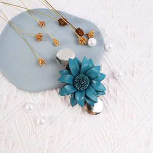 Close-up detail of handmade blue leather flower brooch shawl clip showing exquisite texture details.