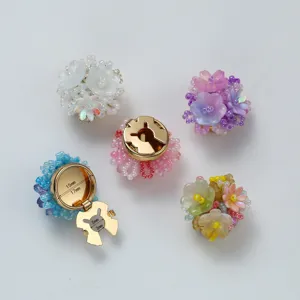 Resin camellia flower decorative buttons cufflinks detail view with metal base and crystal beads.