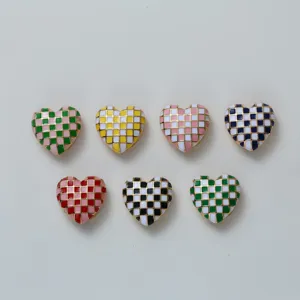 Detailed view of colorful checkered heart buttons, perfect for stylish shirts and clothing.