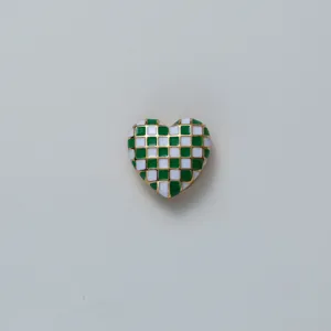 Green and white checkerboard heart shape decorative cufflink detail close up view
