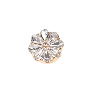 Close-up of a sparkling crystal rhinestone flower cufflink in chic gold tone metal design.