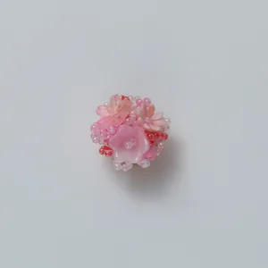 Pink resin camellia bead cluster detail, elegant floral brooch and versatile scarf buckle design.