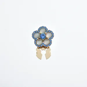 Close-up of a floral rhinestone scarf buckle with blue crystals and a gold-toned metal base.