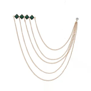 Gold tone multi-strand chain brooch with green rhombus diamond crystals for suit lapel.