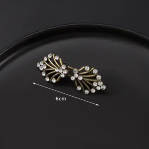 Vintage brass rhinestone scarf clip brooch detail shot, elegant collar accessory for women.