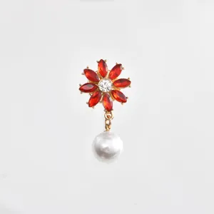 Exquisite red rhinestone flower shirt brooch with elegant dangling pearl pendant detail shot.