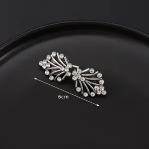 Detailed view of silver rhinestone scarf buckle, elegant collar clip for women and banquets.