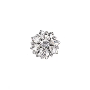 Close-up detail of luxury crystal rhinestone flower metal button brooch for clothing apparel.
