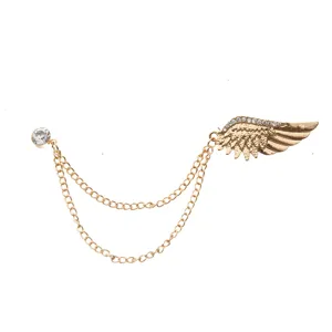 Detailed close up view of golden wing rhinestone chain brooch pin for suit collar.